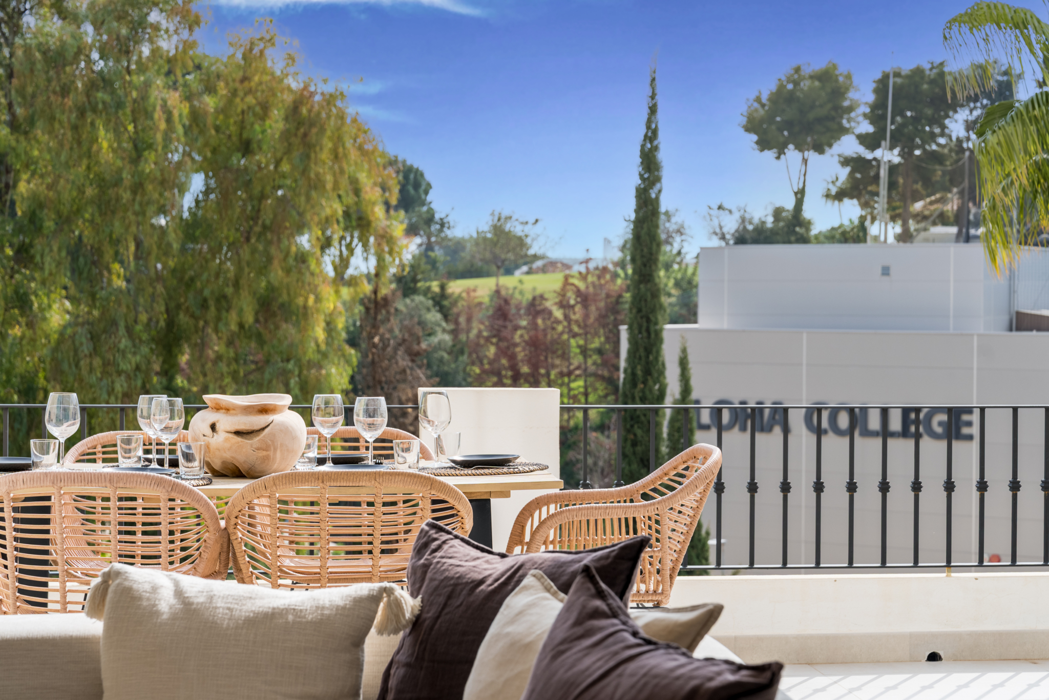 Terrace dining area at Los Pinos de Aloha overlooking Aloha College and lush greenery in Marbella