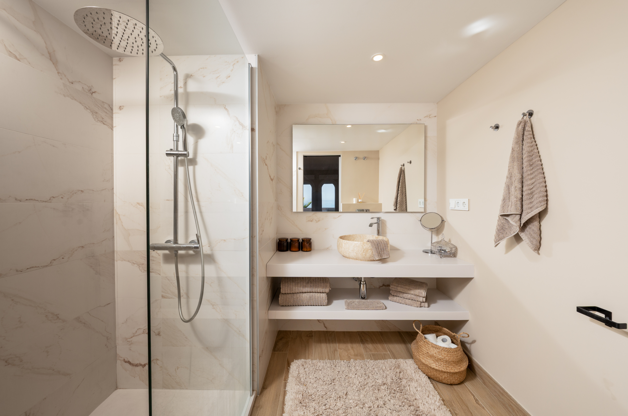 Elegant bathroom with walk-in marble shower and modern vanity in Playa del Moral apartment