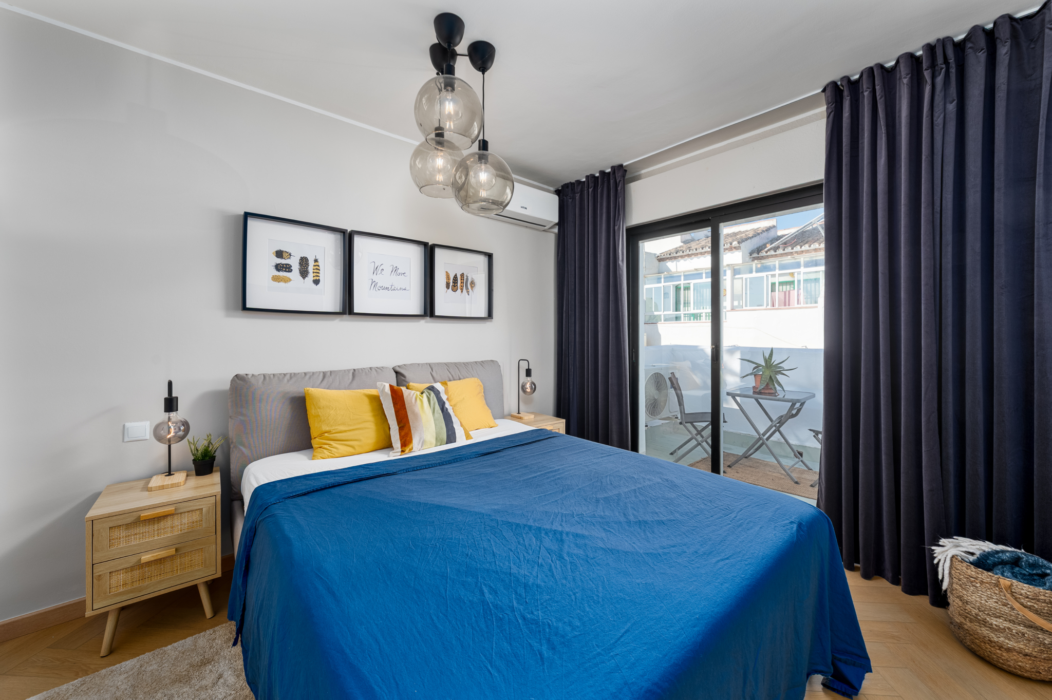 Contemporary bedroom in Bel-Air semi-detached property near Marbella with modern pendant lighting, colorful accents, and balcony access