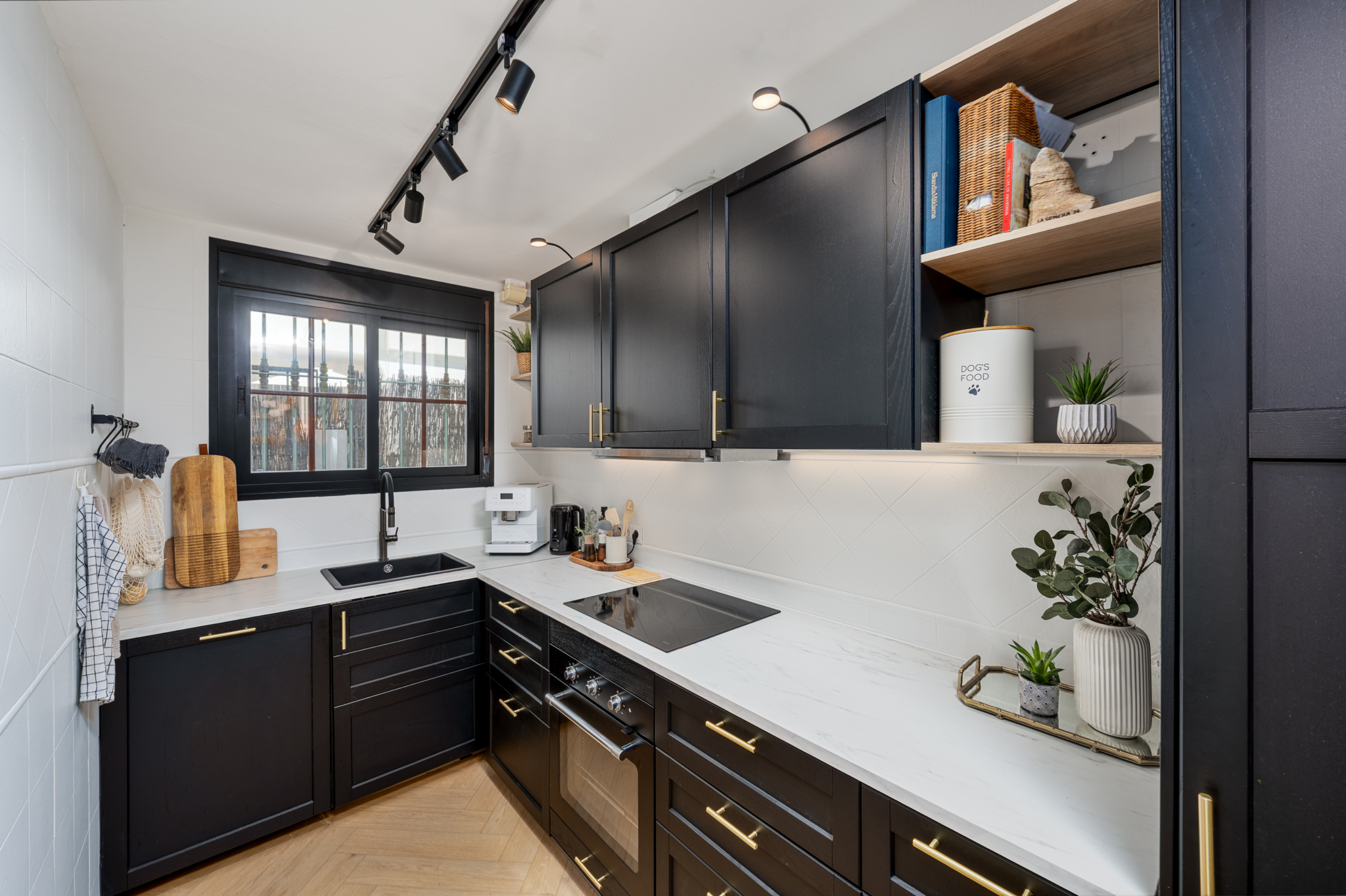 Modern black and white kitchen with gold accents and built-in appliances in Bel-Air semi-detached house, Costa del Sol