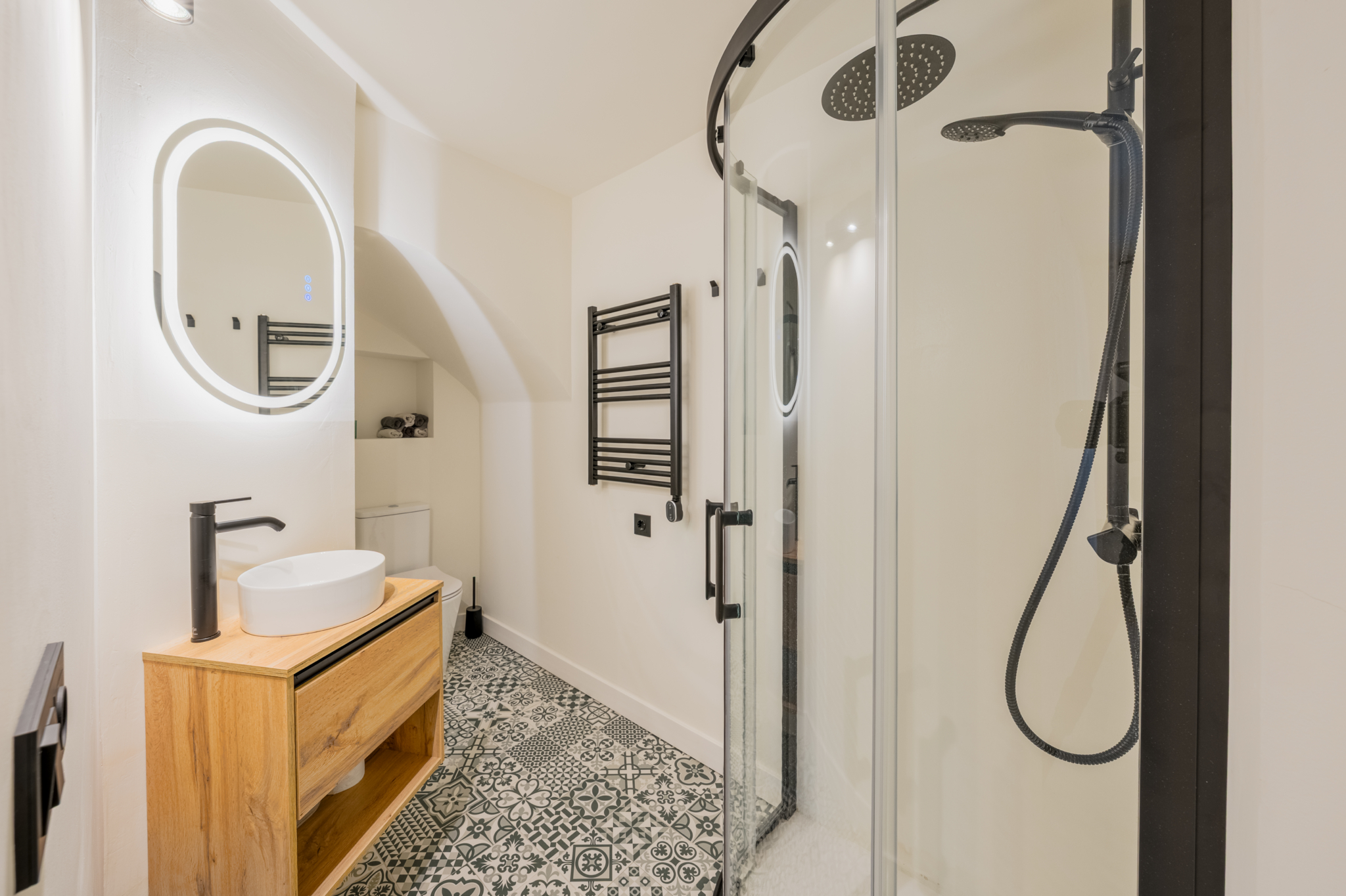 Modern bathroom with walk-in shower and wooden vanity in Estepona Old Town apartment