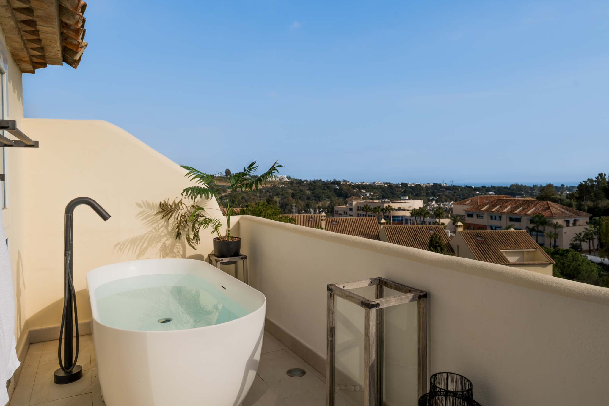 Luxury rooftop terrace with outdoor bathtub and sea views in Los Pinos, Marbella.