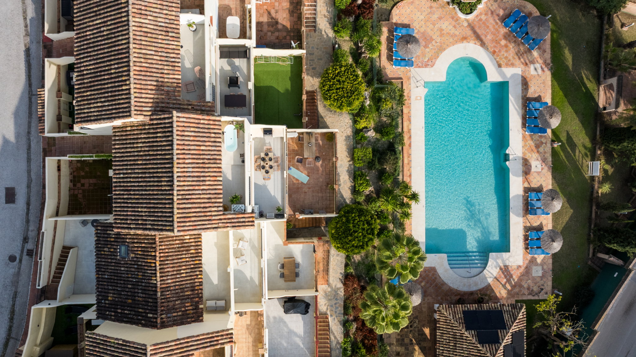 Aerial view of Los Pinos de Aloha with swimming pool and Mediterranean-style architecture in Marbella.
