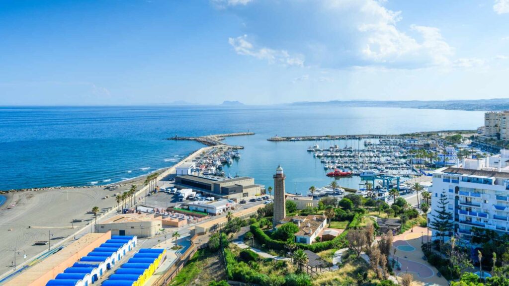 Aerial view of Estepona marina and beachfront apartments on the Costa del Sol, Spain, showcasing prime real estate locations and average property prices in Estepona.