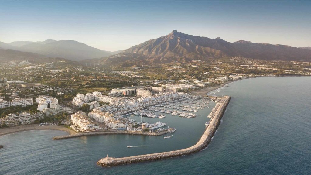 Aerial view of Puerto Banús marina and the exclusive neighborhoods in Nueva Andalucia, Marbella, with La Concha mountain in the background.
