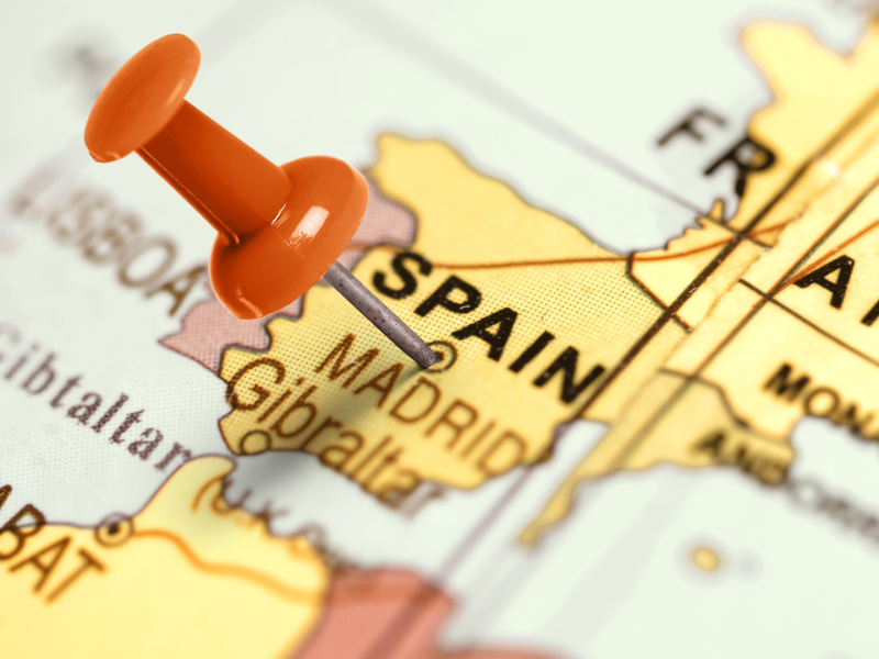 Close-up map of Spain with a red push pin marking Madrid, symbolizing real estate purchase and investment locations in Spain and illustrating key steps for bying property in Spain.